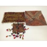 Selection of vintage fabric including African Banjari squares with Cowrie shells, embroidered bag wi