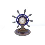 Unusual desk top barometer in the form of a ships wheel with enamel decoration