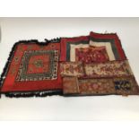 Two vintage African mirror-work sashes and an embroidered wool square with tassel fringing. Plus f