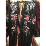 Chinese black silk robe with polychrome silk embroidered flowers, reversible orange silk with flower