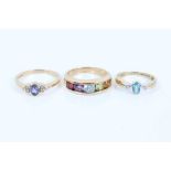 Two 9ct gold oval blue stone rings with diamond set shoulders and 9ct gold five stone multi gem ring
