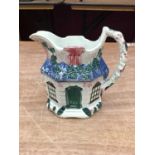 Staffordshire pearlware jug, c.1800, moulded in the form of a cottage and painted in enamels, 12cm h