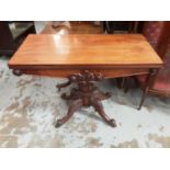 Early Victorian mahogany tea table with fold over revolving top on turned and reeded pedestal with f