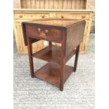 Georgian mahogany three tier side table, the single drawer flanked by twin drop flaps and two plain
