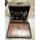Two cased sewing machines, including a Singer and an Ideal Vollzickzack