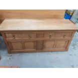 Low oak sideboard with two drawers and two panelled doors below, 152cm wide, 51cm deep, 65.5cm high