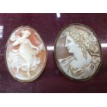 Two oval carved shell cameo brooches to inlcude one in yellow metal mount