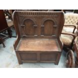 Carved oak hall bench with carved panelled back and rising lid to seat, 86cm wide, 42cm deep, 103cm