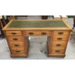 Late 19th / early 20th century satin birch desk, with green leather top and nine drawers about the k