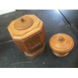 Wooden lidded table top font and another lidded wooden vessel