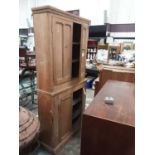 Large pine bookcase with shelved interior enclosed by four panelled doors, 96cm wide, 32cm deep, 197