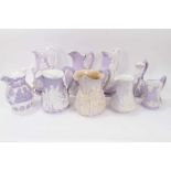 Collection of nine 19th century relief moulded lilac-ground jugs, mostly Samuel Alcock, including th