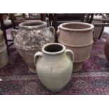Three terracotta two handled garden pots, tallest is 55cm high