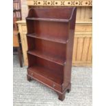 Reproduction mahogany waterfall front open bookcase with single drawer, on bracket feet