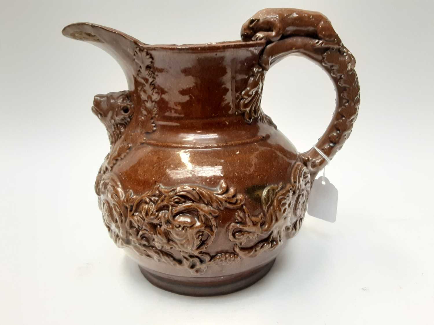 Castle Hedingham Edward Bingham brown glazed pottery jug, with lion on handle and mask decoration, 2