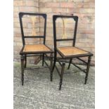 Pair of early 20th century gilt and ebonised bedroom chairs with caned seats