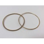 Two 9ct gold bangles to include one plain and one rope twist