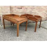 Two mahogany butlers tray occasional tables on stands, each of typical form