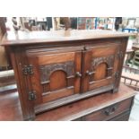 Oak cabinet with two carved panelled doors, 81cm wide, 41cm deep, 49cm high