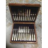 Cased Mother of Pearl handles with silver bandking twelve fruit knives and twelve fruit forks