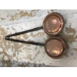Two copper warming pans