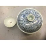 A Qing dynasty style blue and white jar with lid and a small famille rose bowl