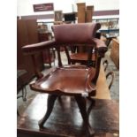 Edwardian revolving desk chair with padded back and arms, polished solid mahogany sear on four hippe