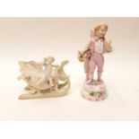 Bisque porcelain figure of a boy carrying a basket on his back, and a bisque porcelain cherub riding