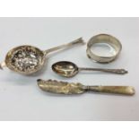 Group of silver to include tea strainer, napkin ring, teaspoon and butter knife