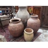 Four terracotta garden pots, largest is 79cm high