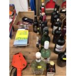 Twelve bottles of alcohol and six alcohol miniatures, mostly spirits, including Akvavit, Martini, Ba