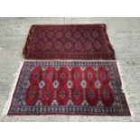 Two Eastern rugs with geometric decoration on red ground 160x104cm, 156x89cm