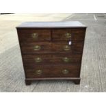 George III oak chest of two short and three long drawers with oval brass handles, on bracket feet