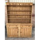 Victorian pine two height kitchen dresser, the raised open back above two drawers and two cupboards