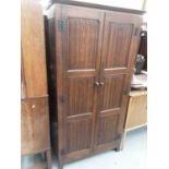 17th century style oak wardrobe enclosed by two linenfold panelled doors