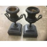 Pair of Victorian bronze urns on square bases