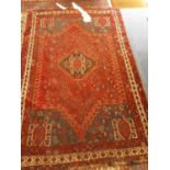 Eastern rug with geometric decoration on red and blue ground, 235cm x 154cm