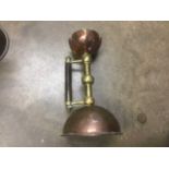Pair of copper and brass candlesticks in a design by Christopher Dresser, 19cm high