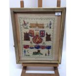 Two 1930s Royal commemorative samplers depicting Buckingham Palace, flags and verse, each in glazed