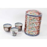 Set of 19th century Japanese Meiji stacking boxes, together with three Imari cups