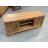 Contemporary light oak television unit, together with a modern beech rocking chair (2)