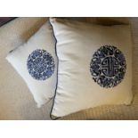 Two good quality linen and silk embroided cushions with Chinese motif to each centre