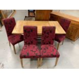 Contemporary light oak square drawleaf table together with four matching chairs with fuscia upholst