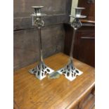 Pair of Art Nouveau-style plated candlesticks with pierced decorative panels