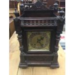 Late 19th century mantel clock with 8 day striking movement by Winterhalder & Hofmeier, in carved oa