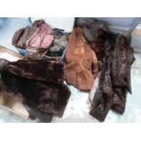 Collection of vintage clothing including fur and faux fur jackets in three old suitcases