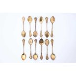 Set of twelve silver gilt ice cream spoons, with ornate cast stems