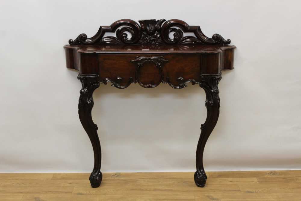 Victorian mahogany console/hall table with carved and pierced back and shaped frieze drawer on scrol