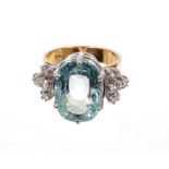 Aquamarine and diamond cocktail ring with a large oval mixed cut aquamarine measuring approximately