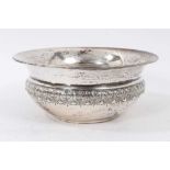 Late Victorian silver bowl with a band of embossed foliate decoration and flared rim